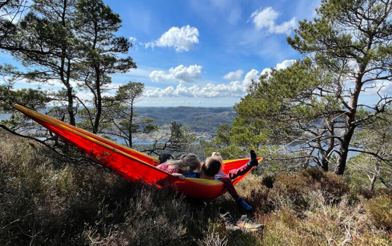 Barn i hengekøye med fin utsikt en sommerdag